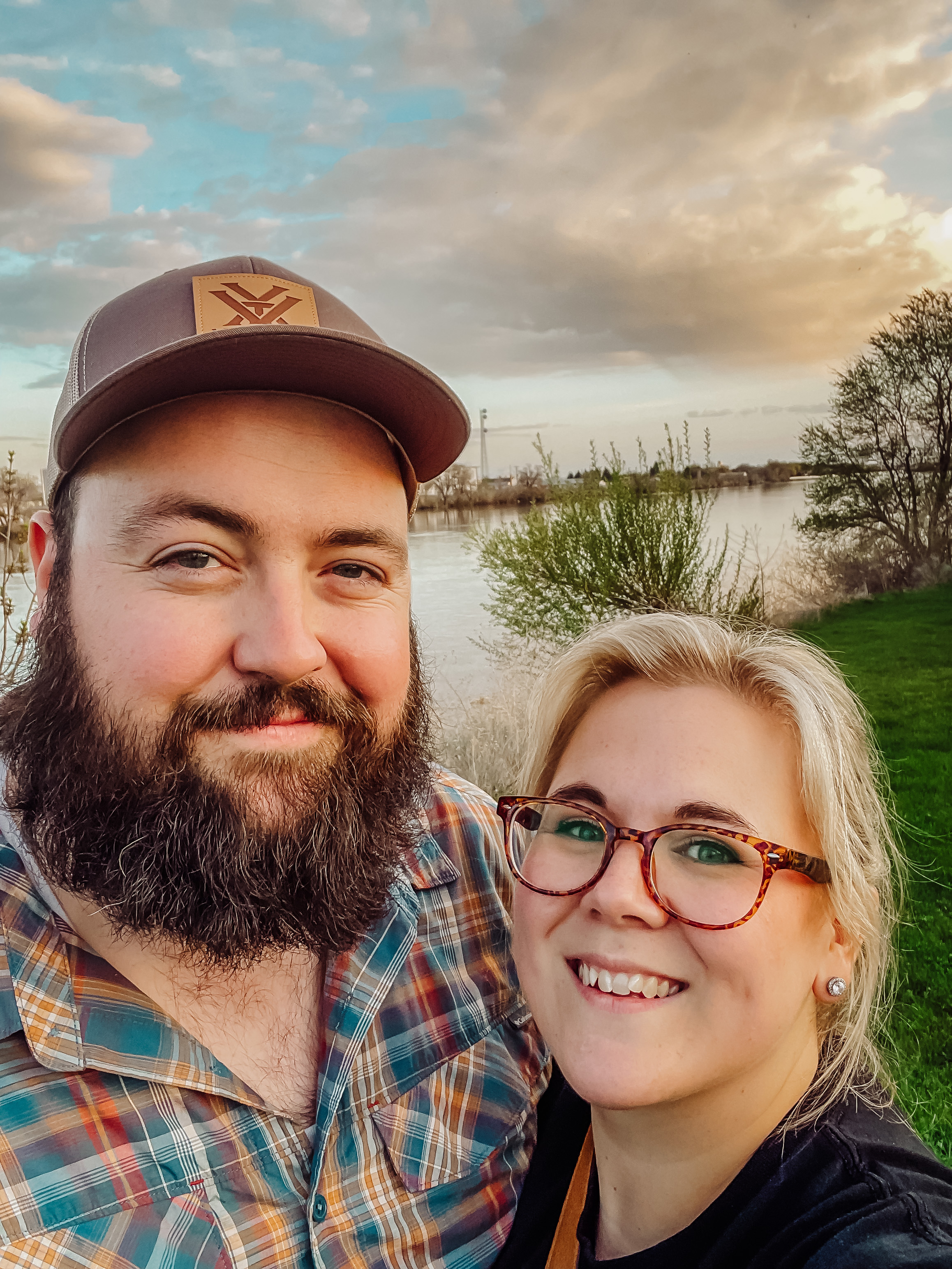 large bearded man and blonde woman stand together smiling